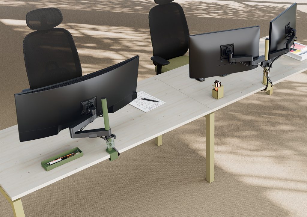 Desk top view with a single monitor arm and a dual monitor arm. The column and clamp of the single monitor arm are in botanical green to match the desk accessories. The column and clamp of the dual monitor arm are in putty to match the desk legs and desk accessories.